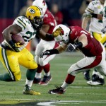 Green Bay Packers running back Eddie Lacy (27) is hit by Arizona Cardinals' Josh Mauro (97) during the first half of an NFL divisional playoff football game, Saturday, Jan. 16, 2016, in Glendale, Ariz. (AP Photo/Rick Scuteri)