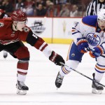 Arizona Coyotes' Connor Murphy (5) pokes the puck away from Edmonton Oilers' Taylor Hall (4) during the first period of an NHL hockey game Tuesday, Jan. 12, 2016, in Glendale, Ariz. (AP Photo/Ross D. Franklin)