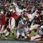 Carolina Panthers' Cam Newton dives into the end zone for a touchdown during the first half the NFL football NFC Championship game against the Arizona Cardinals, Sunday, Jan. 24, 2016, in Charlotte, N.C. (AP Photo/Chuck Burton)