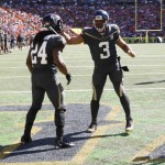 Atlanta Falcons running back Devonta Freeman (24) and Seattle Seahawks quarterback Russell Wilson (3) T of Team Irvin  celebrate after Freeman made a touchdown during the first quarter of the NFL Pro Bowl football game, Sunday, Jan. 31, 2016, in Honolulu. (AP Photo/Marco Garcia)