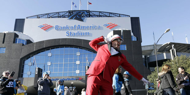 Arizona Cardinals fan John Guerriero poses for a picture outside Bank of America Stadium before the...