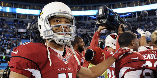 Arizona Cardinals' Larry Fitzgerald stands with his teammates before the NFL football NFC Champions...