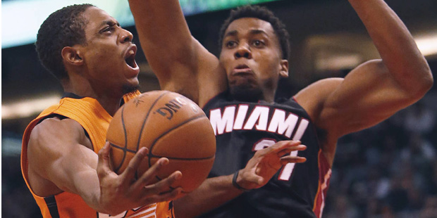 Phoenix Suns guard Brandon Knight, left, drives on Miami Heat center Hassan Whiteside during the fo...