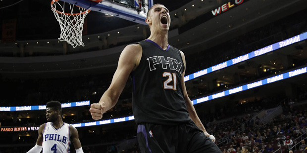 Phoenix Suns' Alex Len reacts after a dunk during the first half of an NBA basketball game against ...