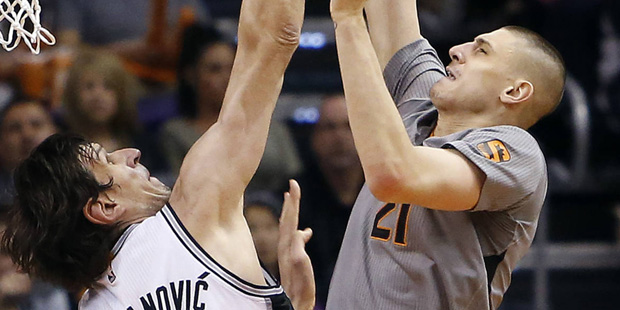 Phoenix Suns center Alex Len shoots over San Antonio Spurs center Boban Marjanovic (40) during the ...