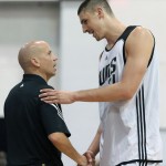 Phoenix Suns' Alex Len, right, shakes hands with head coach Nate Bjorkgren towards the end of the second half of an NBA summer league basketball game against the Washington Wizards, Saturday, July 11, 2015, in Las Vegas. (AP Photo/Ronda Churchill)