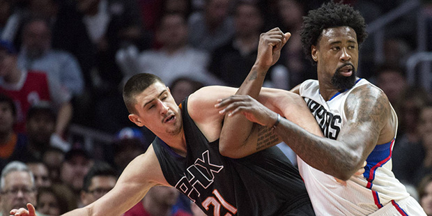 Clippers' DeAndre Jordan, right, and the Suns' Alex Len fight for a position during a game at Stapl...
