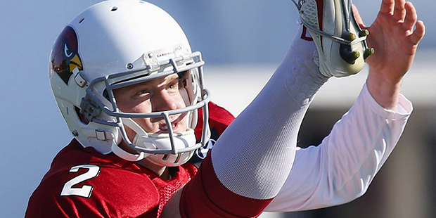 Arizona Cardinals punter Drew Butler watches the flight of a punt during NFL football practice at C...
