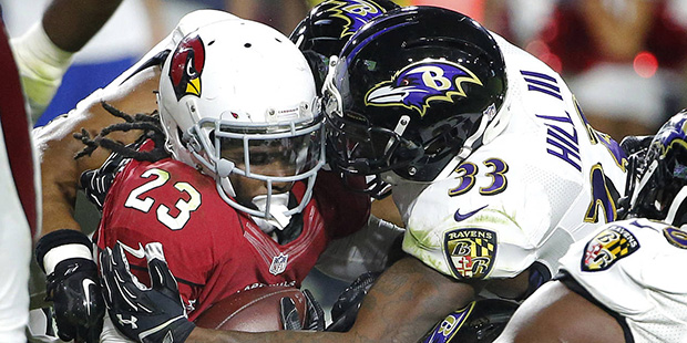 Arizona Cardinals running back Chris Johnson (23) is hit by Baltimore Ravens strong safety Will Hil...