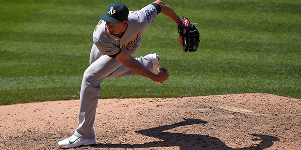 Oakland Athletics relief pitcher Tyler Clippard throws to the plate during the ninth inning of a ba...