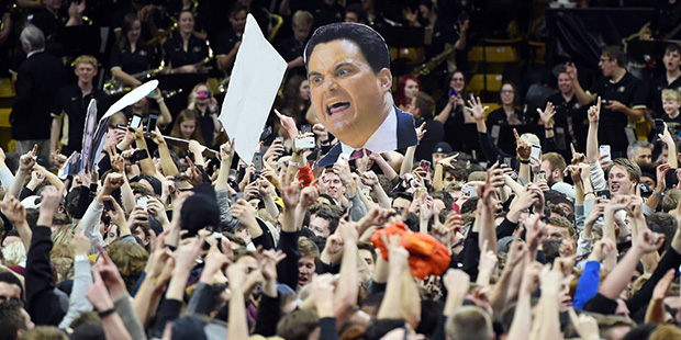 Colorado fans storm the court after Colorado defeated Arizona 75-72 in an NCAA college basketball g...