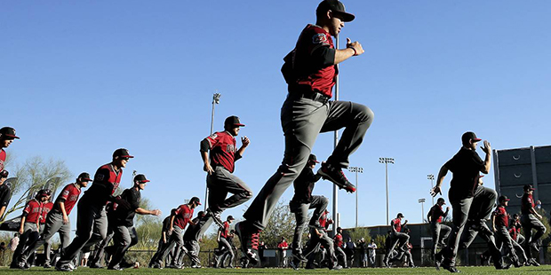 Arizona Diamondbacks pithchers and catchers run during a spring training baseball practice, Monday,...