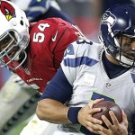Seattle Seahawks quarterback Russell Wilson (3) is sacked by Arizona Cardinals inside linebacker Dwight Freeney (54) during the second half of an NFL football game, Sunday, Jan. 3, 2016, in Glendale, Ariz. (AP Photo/Rick Scuteri)