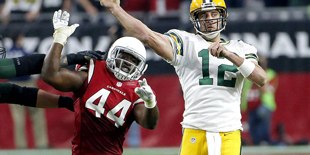 Green Bay Packers quarterback Aaron Rodgers (12) throws under pressure from Arizona Cardinals outsi...