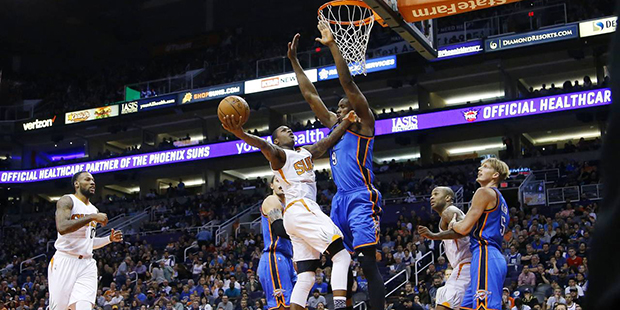 Phoenix Suns' Archie Goodwin tries to get off a shot over Oklahoma City Thunder's Serge Ibaka (9), ...