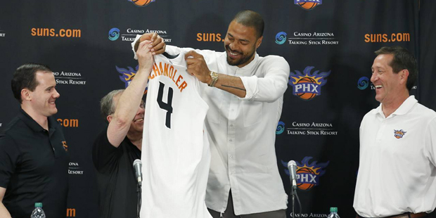 Phoenix Suns' Tyson Chandler, second from right, drapes his new uniform over Suns senior adviser Lo...
