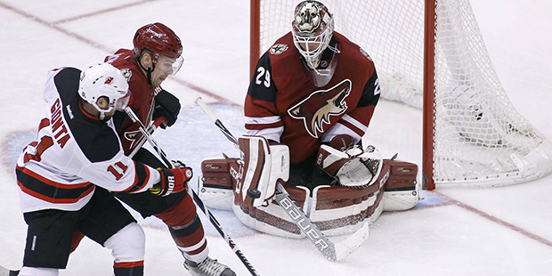 Arizona Coyotes goalie Anders Lindback (29) makes a blocker save as New Jersey Devils' Stephen Gion...
