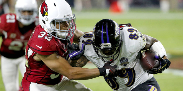 Baltimore Ravens wide receiver Steve Smith (89) is stopped by Arizona Cardinals free safety Tyrann ...