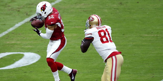 Arizona Cardinals free safety Tyrann Mathieu (32) intercepts a pass for a touchdown as San Francisco 49ers wide receiver Anquan Boldin (81) misses the catch during the first half of an NFL football game, Sunday, Sept. 27, 2015, in Glendale, Ariz.  (AP Photo/Rick Scuteri)