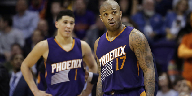 Phoenix Suns' P.J. Tucker (17) and Devin Booker (1) react to a foul call during the second half of ...