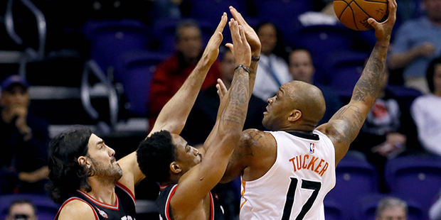 Phoenix Suns' P.J. Tucker (17) shots over Toronto Raptors' DeMar DeRozan and Luis Scola, of Argenti...
