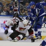 Arizona Coyotes' Connor Murphy (5) and Viktor Tikhonov (9), of Latvia, collide in front of Tampa Bay Lightning's Erik Condra (22) during the first period of an NHL hockey game Tuesday, Feb. 23, 2016, in Tampa, Fla. (AP Photo/Mike Carlson)