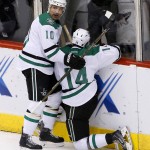 Dallas Stars' Jamie Benn (14) celebrates his goal against the Arizona Coyotes with Patrick Sharp (10) during the second period of an NHL hockey game Thursday, Feb. 18, 2016, in Glendale, Ariz. (AP Photo/Ross D. Franklin)