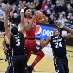 Arizona guard Allonzo Trier drives past Colorado's Xavier Talton (3) and George King during the first half of an NCAA college basketball game Wednesday, Feb. 24, 2016, in Boulder, Colo. (AP Photo/Cliff Grassmick)