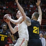 Utah forward Jakob Poeltl (42) looks to shoot over Arizona State forward Eric Jacobsen (21) during the first half of an NCAA college basketball game in Salt Lake City, Thursday, Feb. 25, 2016.  (AP Photo/George Frey)