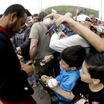 Fans try for a autograph from Arizona Diamondbacks right fielder Yasmany Tomas during a spring baseball practice in Scottsdale, Ariz., Friday, Feb. 19, 2016. (AP Photo/Chris Carlson)