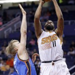 Phoenix Suns' Markieff Morris (11) drives past Oklahoma City Thunder's Kyle Singler, left, to score during the second half of an NBA basketball game Monday, Feb. 8, 2016, in Phoenix. The Thunder defeated the Suns 122-106. (AP Photo/Ross D. Franklin)