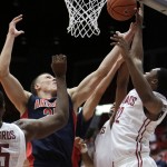 Arizona's Kaleb Tarczewski, second from left, goes after a rebound against Washington State's Que Johnson, right, and Renard Suggs during the second half of an NCAA college basketball game, Wednesday, Feb. 3, 2016, in Pullman, Wash. Arizona won 79-64. (AP Photo/Young Kwak)