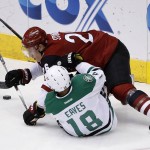 Arizona Coyotes' Michael Stone (26) sends Dallas Stars' Patrick Eaves (18) to the ice during the second period of an NHL hockey game Thursday, Feb. 18, 2016, in Glendale, Ariz. (AP Photo/Ross D. Franklin)