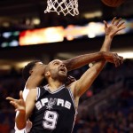 San Antonio Spurs guard Tony Parker (9) draws the foul on Phoenix Suns guard Ronnie Price in the fourth quarter of an NBA basketball game, Sunday, Feb. 21, 2016, in Phoenix. The Spurs won 118-111. (AP Photo/Rick Scuteri)
