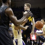Arizona State's Kodi Justice (44) passes behind his back to Savon Goodman during the first half of the team's NCAA college basketball game against Washington on Wednesday, Feb. 3, 2016, in Seattle. Goodman dunked to complete the play. (AP Photo/Elaine Thompson)