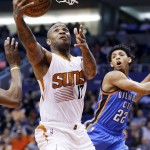 Phoenix Suns' P.J. Tucker (17) drives past Oklahoma City Thunder's Cameron Payne (22) to score during the second half of an NBA basketball game Monday, Feb. 8, 2016, in Phoenix.  The Thunder defeated the Suns 122-106. (AP Photo/Ross D. Franklin)