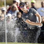 Zach Johnson hits out of the sand on the fourth hole during the first round of the Phoenix Open golf tournament, Thursday, Feb. 4, 2016, in Scottsdale, Ariz. (AP Photo/Rick Scuteri)