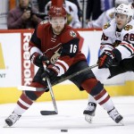 Arizona Coyotes' Max Domi (16) and Chicago Blackhawks' Teuvo Teravainen (86), of Finland, battle for the puck during the second period of an NHL hockey game Thursday, Feb. 4, 2016, in Glendale, Ariz. (AP Photo/Ross D. Franklin)