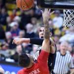 Colorado forward Josh Scott blocks the shot of Arizona's Gabe York during the first half of an NCAA college basketball game Wednesday, Feb. 24, 2016, in Boulder, Colo. (AP Photo/Cliff Grassmick)