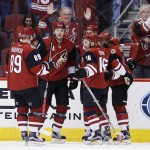 From left, Arizona Coyotes' Mikkel Boedker, of Denmark, Martin Hanzal, of the Czech Republic, Max Domi, Oliver Ekman-Larsson, of Sweden, and Anthony Duclair celebrate Ekman-Larsson's goal against the Chicago Blackhawks during the first period of an NHL hockey game Thursday, Feb. 4, 2016, in Glendale, Ariz. (AP Photo/Ross D. Franklin)