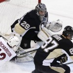 Arizona Coyotes' Brad Richardson (12) slides into Pittsburgh Penguins goalie Marc-Andre Fleury (29) after having a shot blocked by Fleury during the first period of an NHL hockey game in Pittsburgh, Monday, Feb. 29, 2016. (AP Photo/Gene J. Puskar)