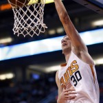 Phoenix Suns forward Jon Leuer dunks against the San Antonio Spurs in the first quarter during an NBA basketball game, Sunday, Feb. 21, 2016, in Phoenix. (AP Photo/Rick Scuteri)