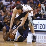 Phoenix Suns forward Mirza Teletovic, top, and Memphis Grizzlies forward JaMychal Green (0) scramble for the ball during the fourth quarter of an NBA basketball game Saturday, Feb. 27, 2016, in Phoenix. The Suns defeated the Grizzlies 111-106. (AP Photo/Rick Scuteri)