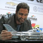 Actor Gerard Butler poses with the Daytona 500 winner's trophy during a news conference before the NASCAR Daytona 500 Sprint Cup Series auto race at Daytona International Speedway in Daytona Beach, Fla., Sunday, Feb. 21, 2016. Butler is the Grand Marshall of the race. (AP Photo/Terry Renna)
