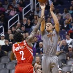 Phoenix Suns guard Devin Booker (1) shoots over Houston Rockets guard Patrick Beverley during the third quarter of an NBA basketball game, Thursday, Feb. 4, 2016, in Phoenix. The Rockets won 111-105. (AP Photo/Rick Scuteri)
