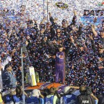 Denny Hamlin, center, celebrates in Victory Lane after winning the NASCAR Daytona 500 Sprint Cup Series auto race at Daytona International Speedway in Daytona Beach, Fla., Sunday, Feb. 21, 2016. (AP Photo/David Graham)