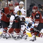 Arizona Coyotes' Kevin Connauton (44) has the puck go past him as Chicago Blackhawks' Niklas Hjalmarsson (4), of Sweden, has the puck hit off him, while Coyotes' Michael Stone, second from left, and Blackhawks' Artem Anisimov, left, of Russia, mix it up in front of the goal during the second period of an NHL hockey game Thursday, Feb. 4, 2016, in Glendale, Ariz. (AP Photo/Ross D. Franklin)