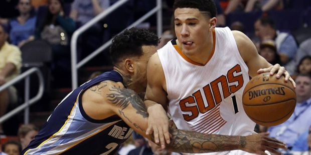 Phoenix Suns guard Devin Booker (1) drives on Memphis Grizzlies forward Matt Barnes during the thir...