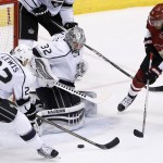Los Angeles Kings' Jonathan Quick (32) stops a shot by Arizona Coyotes' Anthony Duclair (10) as Kings' Trevor Lewis (22) defends during the second period of an NHL hockey game Tuesday, Feb. 2, 2016, in Glendale, Ariz. (AP Photo/Ross D. Franklin)