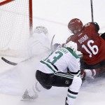 Arizona Coyotes' Max Domi (16) scores a goal against Dallas Stars' Antti Niemi, back left, of Finland, as Stars' Alex Goligoski (33) defends and Coyotes' Anthony Duclair, right, looks on during the second period of an NHL hockey game Thursday, Feb. 18, 2016, in Glendale, Ariz. (AP Photo/Ross D. Franklin)